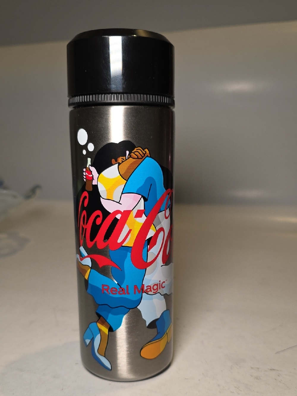 Coca-Cola Silver‎ Bottle with Red Logo and Blue/Yellow Artwork